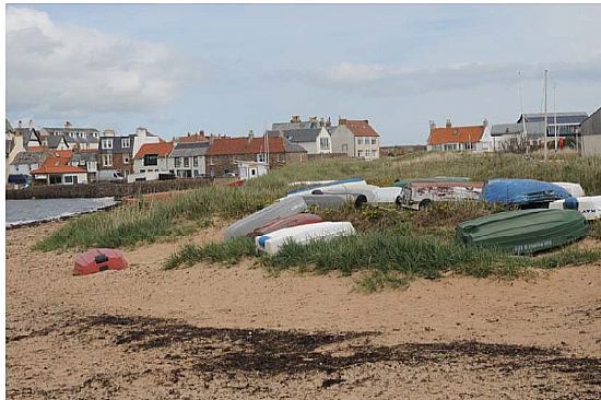 Boats stored beside sand dunes at Elie harbour